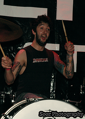 a man playing drums on stage