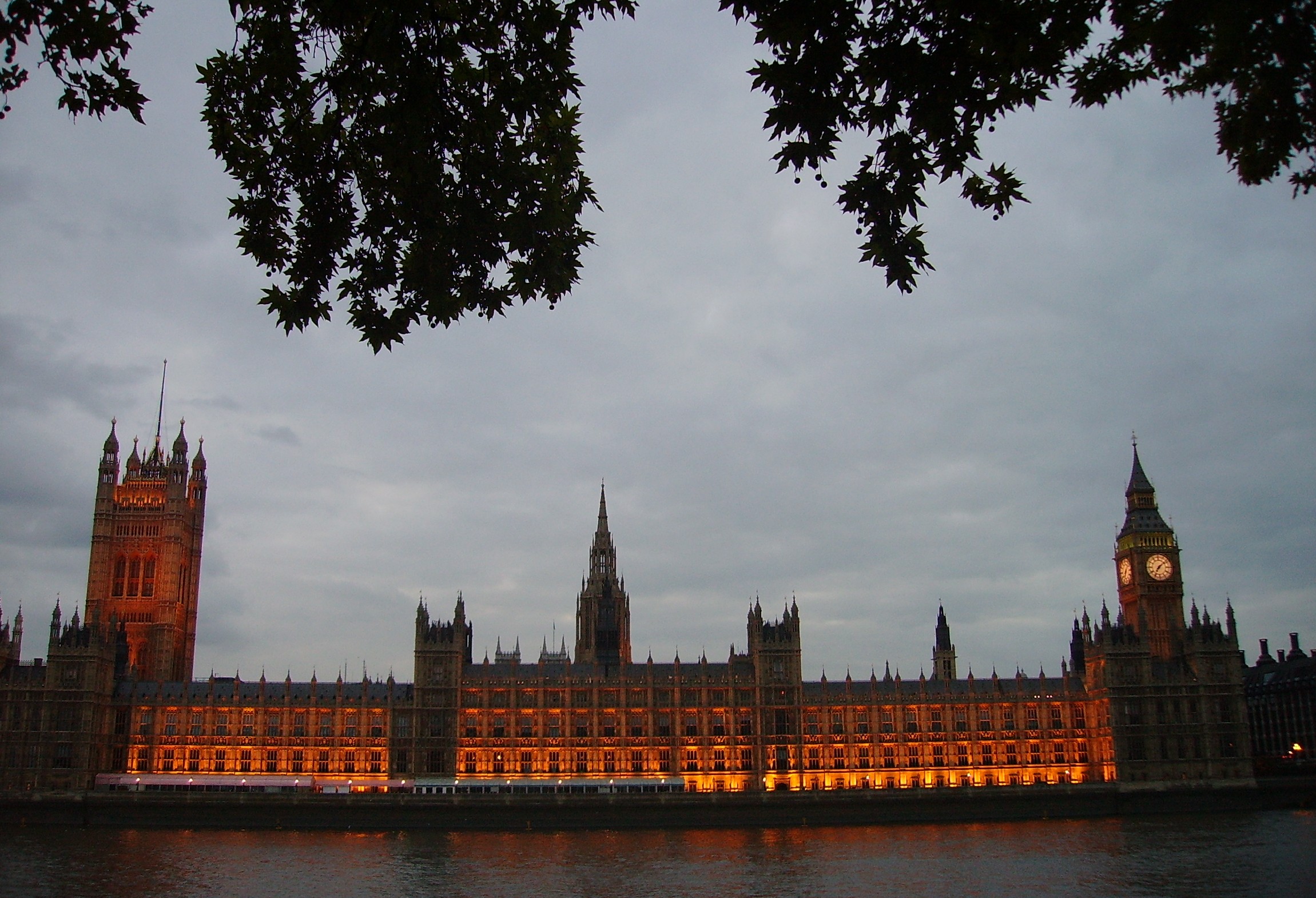 a big building lit up at night with a clock tower