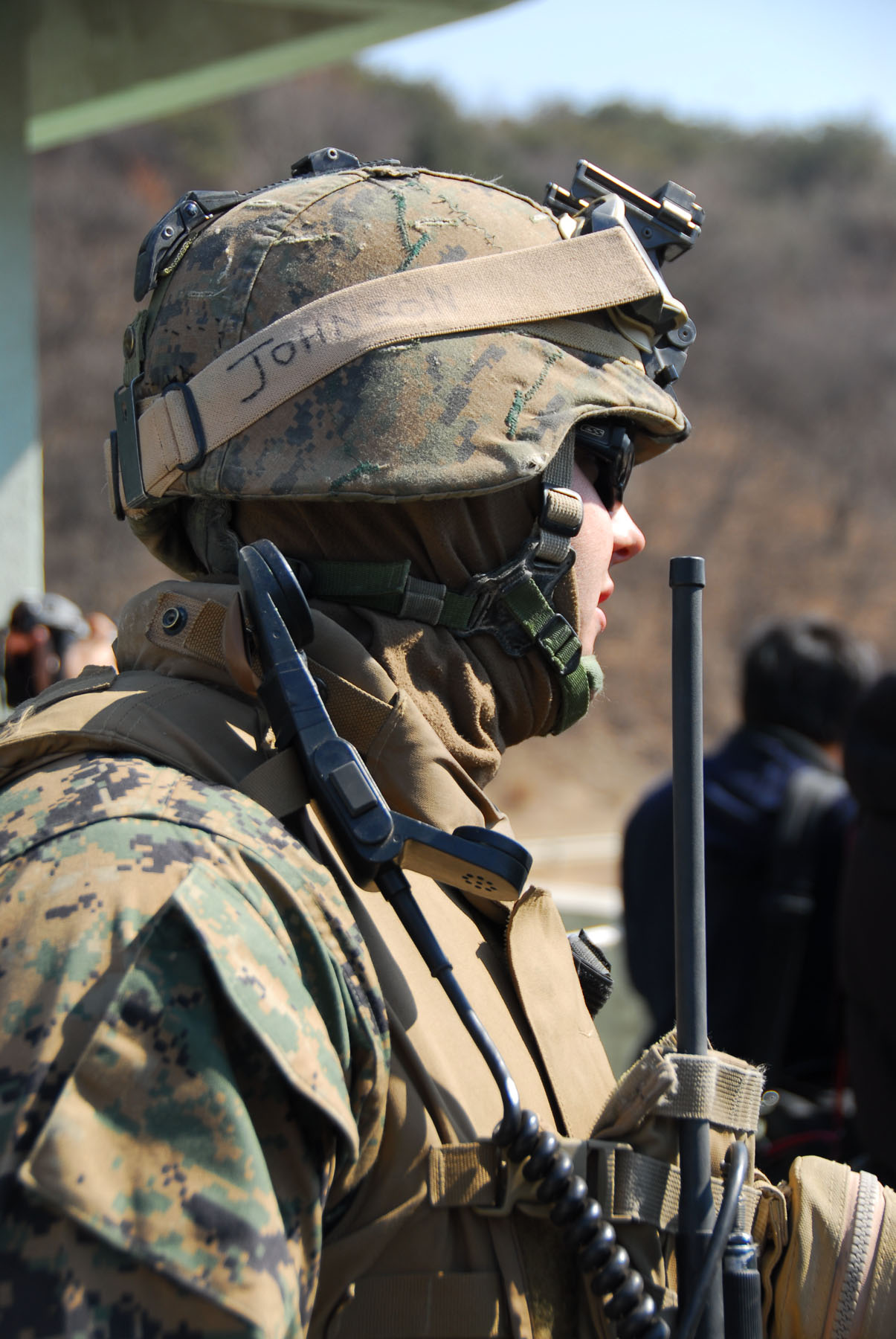 military man with guns and helmet facing away