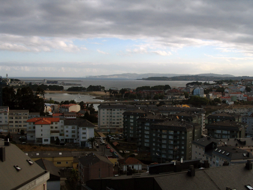 a city filled with tall buildings and water in the distance