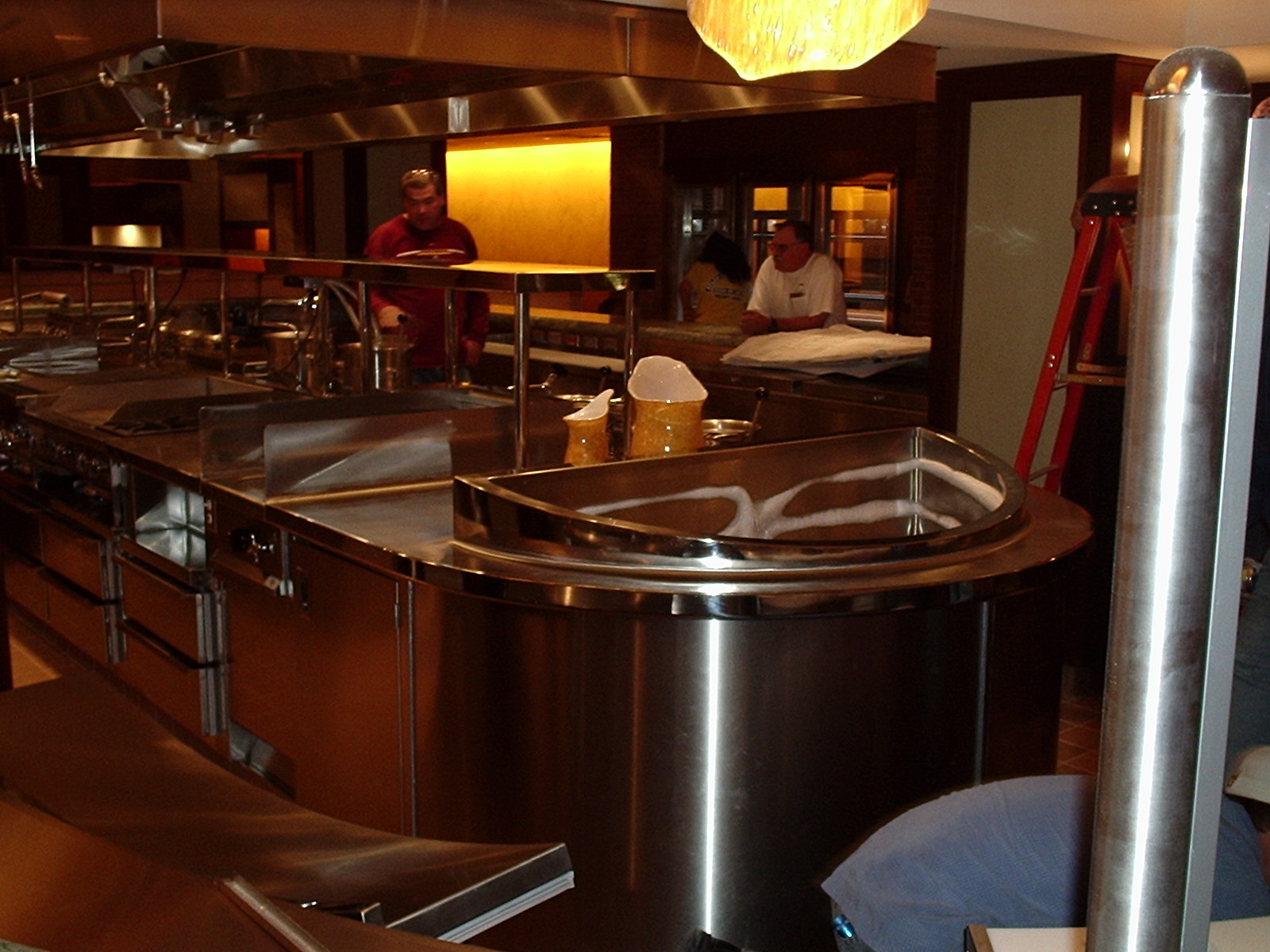 the restaurant kitchen has metal appliances and stainless steel sinks