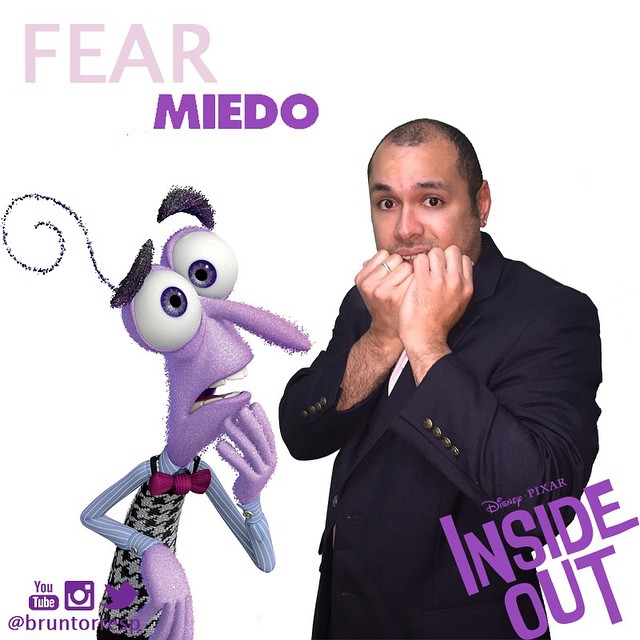 a man is standing next to a purple cartoon character