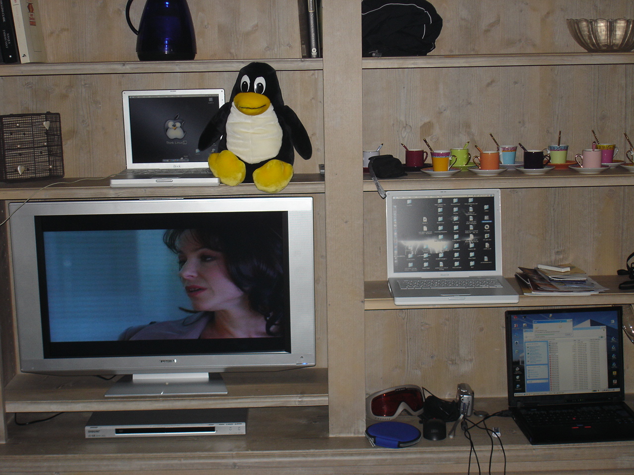 a penguin sitting in front of a television