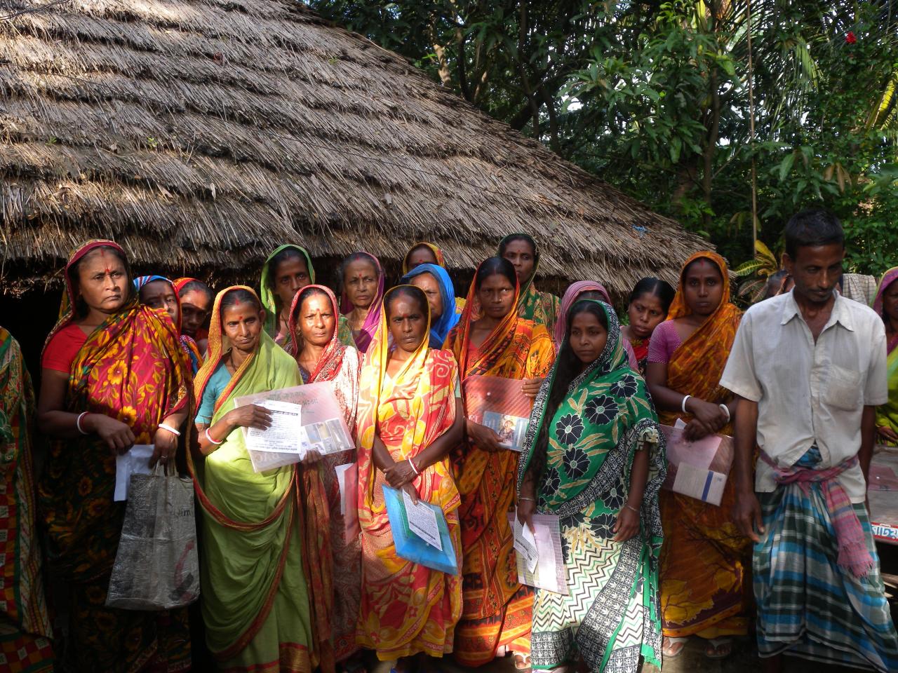 a group of women in colorful dresses standing together