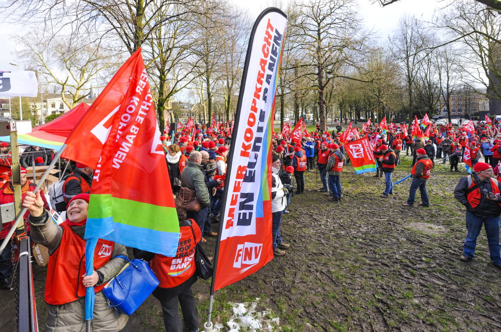 a group of people are gathered holding flags