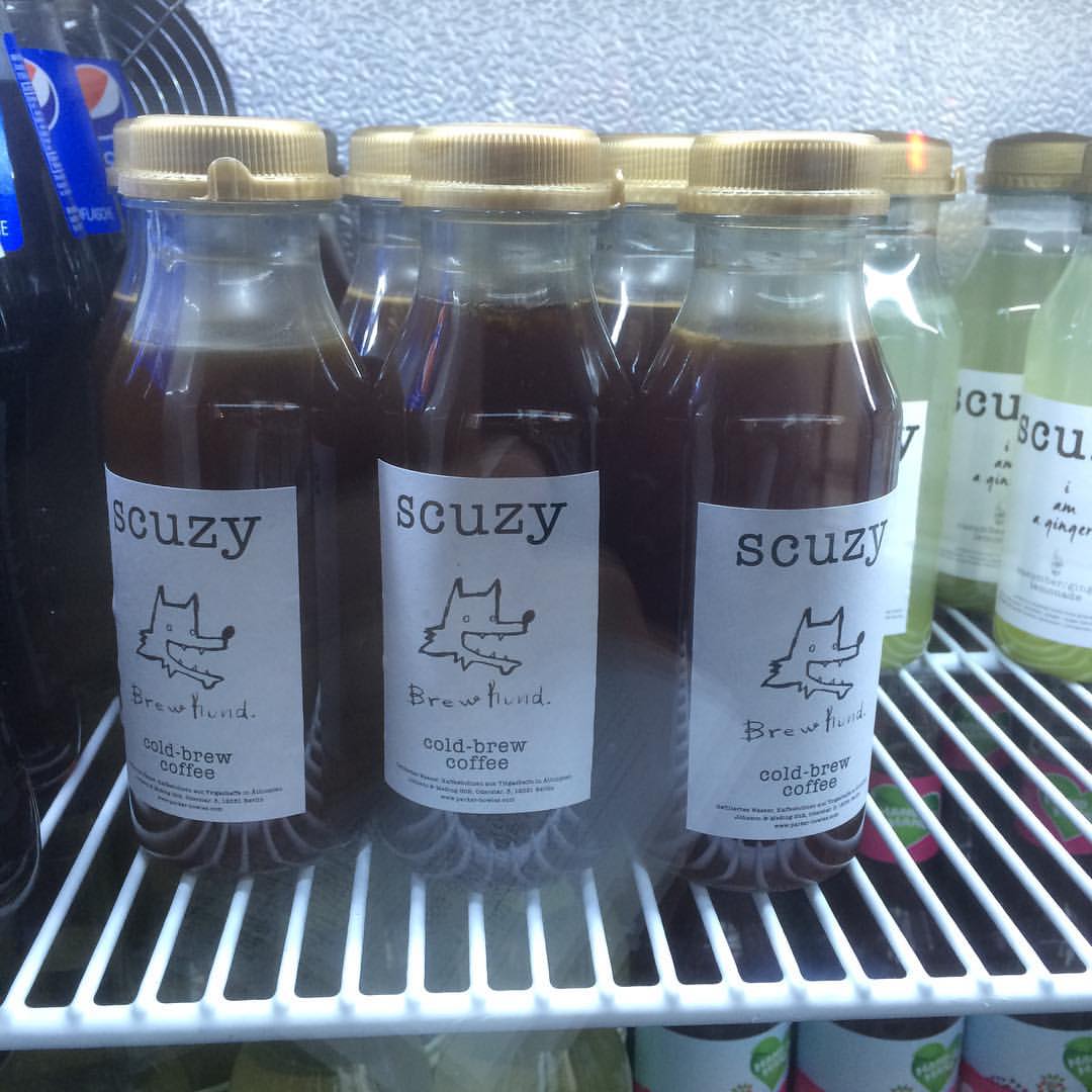 various drinks sit on shelves in a grocery store