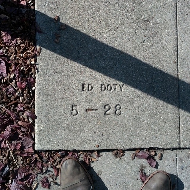 a person's feet are standing in front of a marker