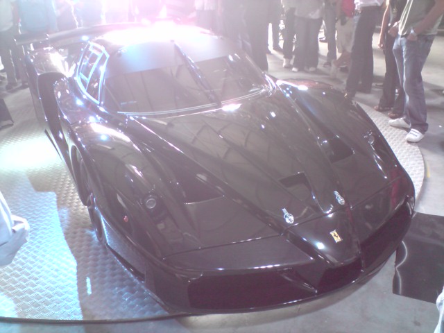 a black sports car on display at a show