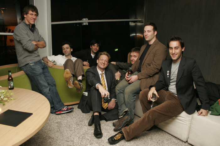 a group of men sitting on a couch together