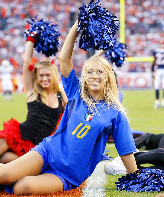 some s wearing cheerleader outfits while sitting on a field