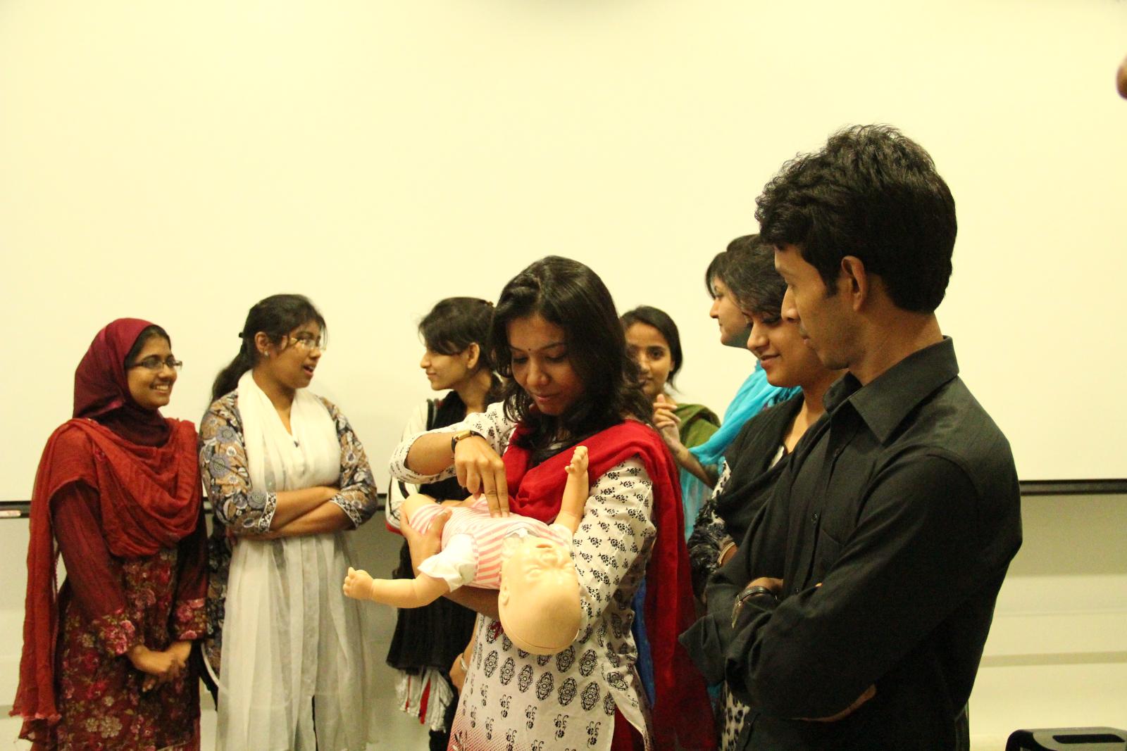 a group of people stand together with a baby
