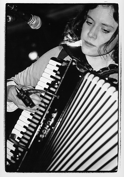an old po of a girl playing an accordion