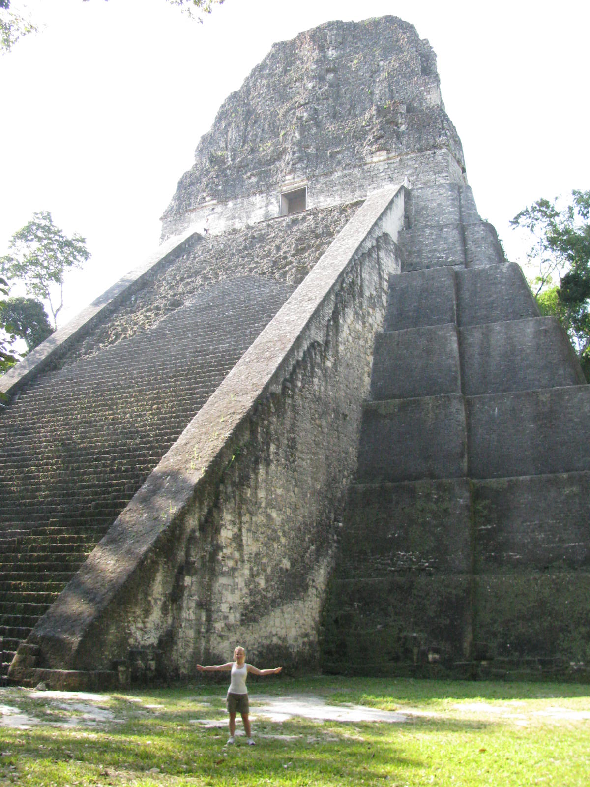 a man is in front of a very large structure