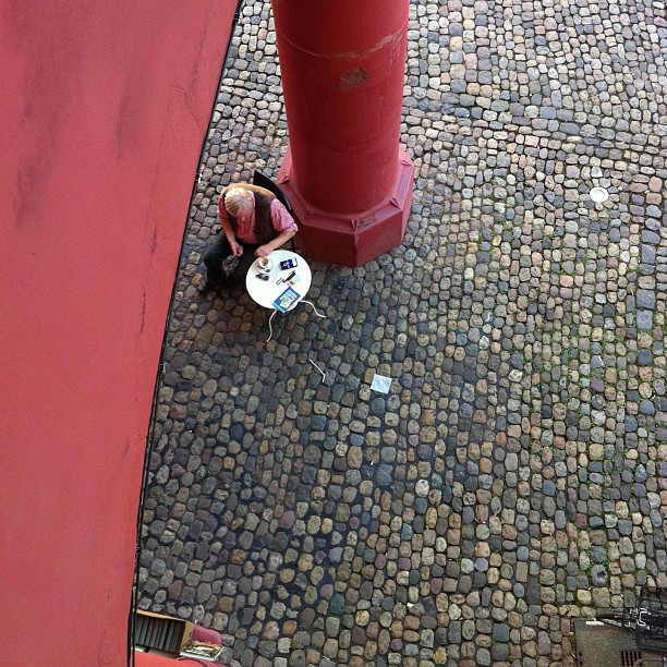 a man holding a table sitting on the ground