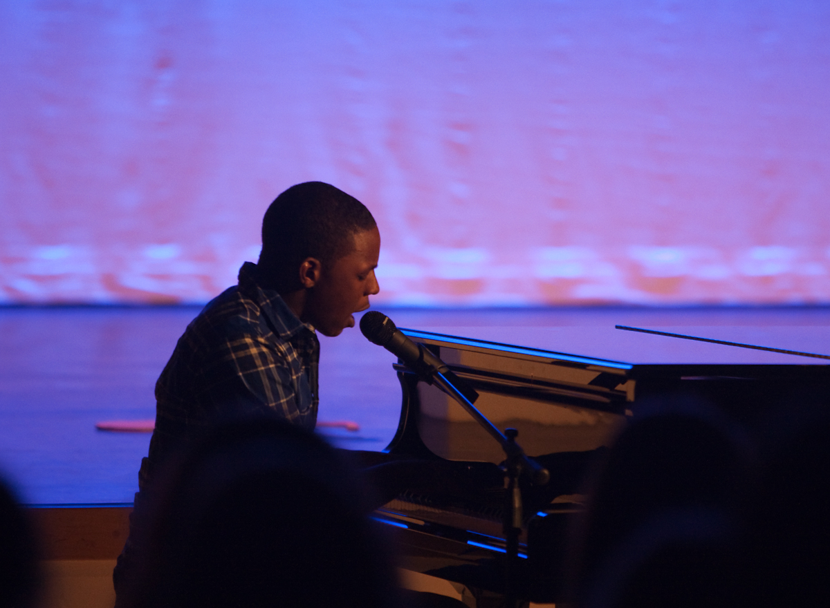 a man is sitting at a piano playing