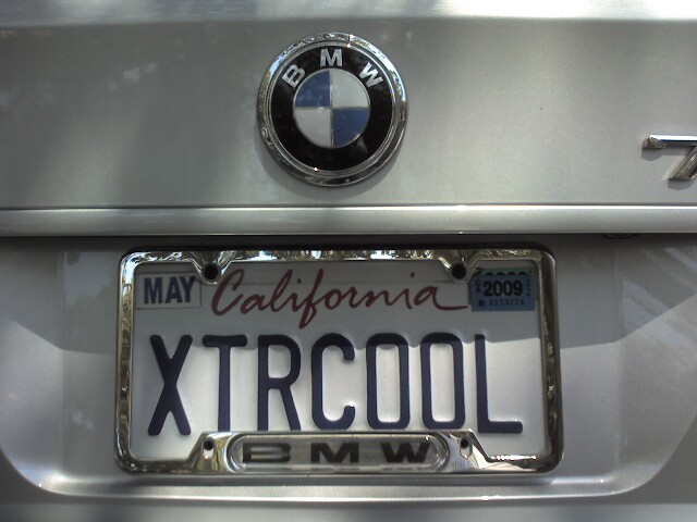 the license plate of the car has the logo of the bmw x - trcola