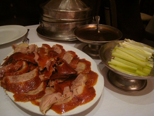 a plate full of meat, celery and apples