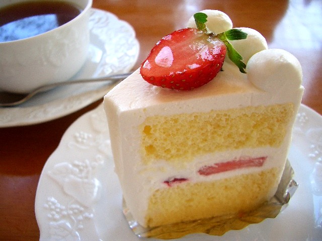 there is a piece of cake with strawberries on it