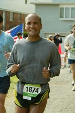 man wearing a shirt and running in a race