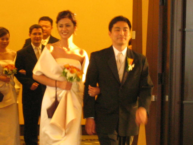 a man and woman walking through a hallway