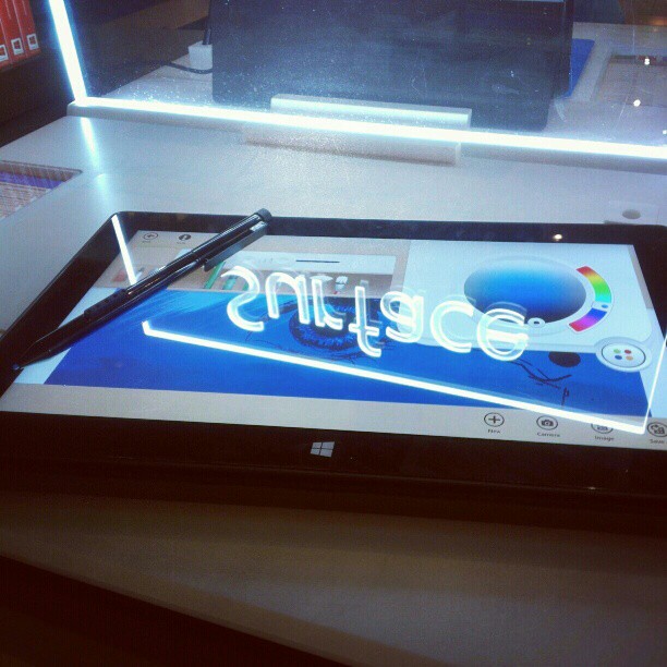 a tablet sitting on top of a table next to a window