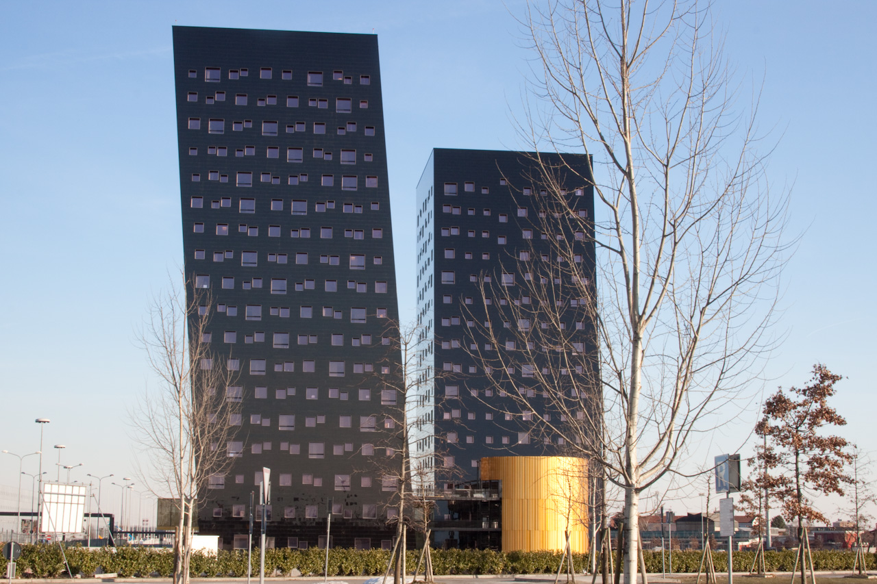 two buildings are near one another on the road