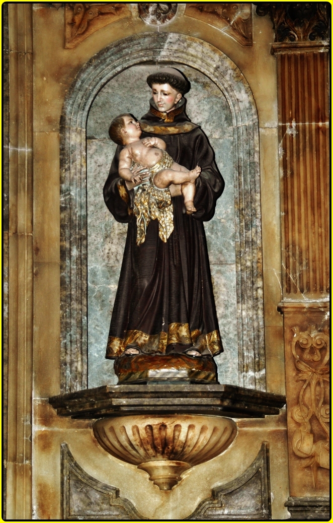 statue of a nun and child surrounded by art work