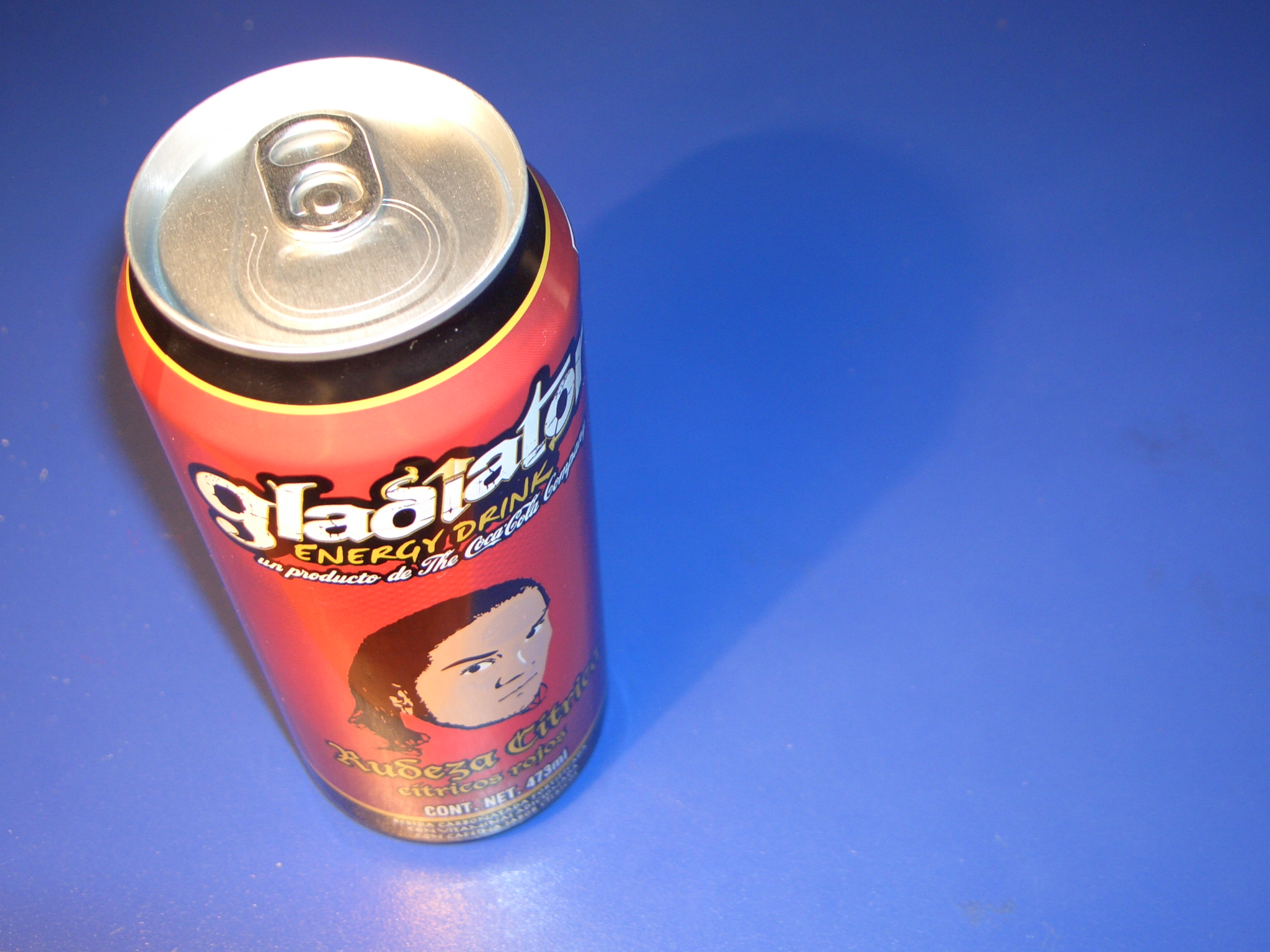 a canned drink sitting on a blue table