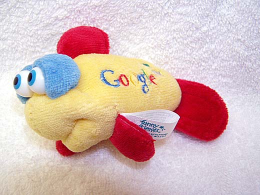 a stuffed toy is lying on a white surface