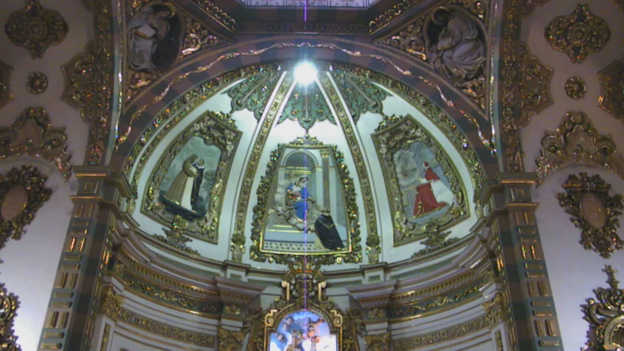 the ceiling in a church has many pictures on it