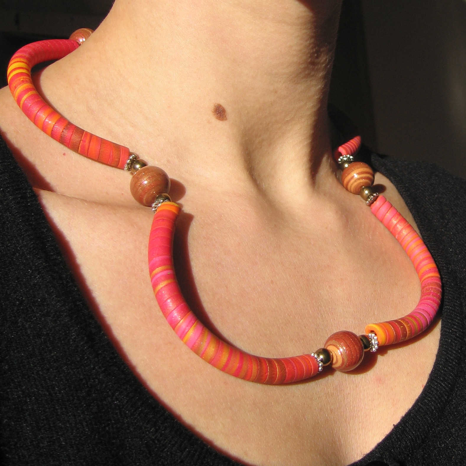 a necklace made with wooden beads in different colors