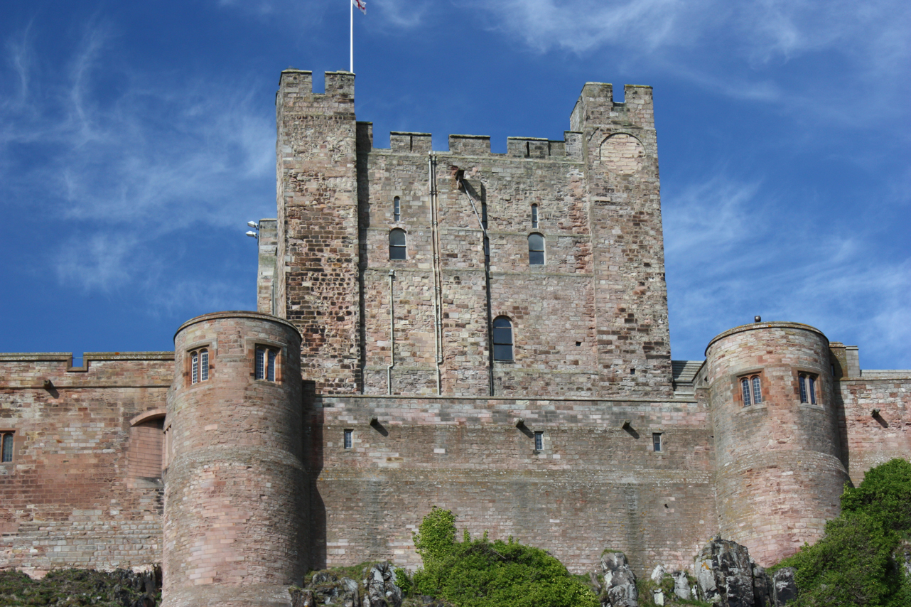 an old castle tower against a bright blue sky