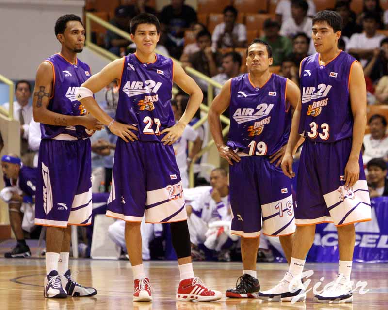 three basketball players standing next to each other on a court