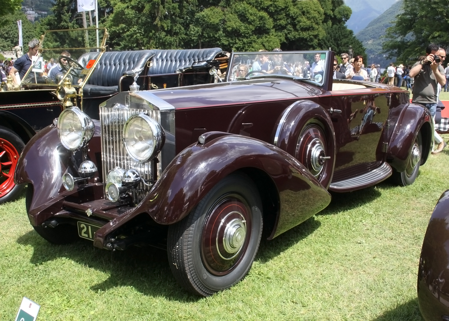 an old style car on display on some grass
