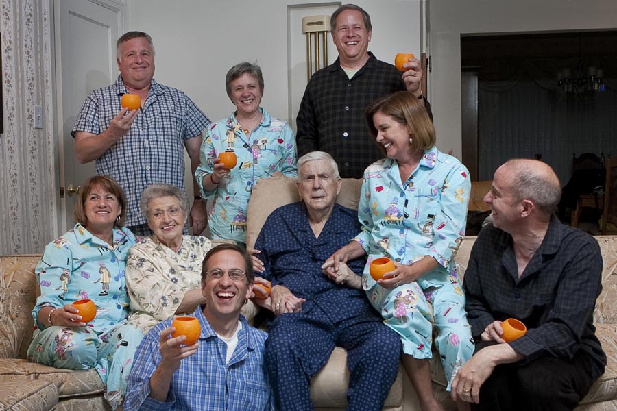 a family poses with some drinks on a couch