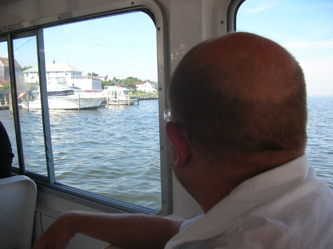 a man is looking out from a boat in the water