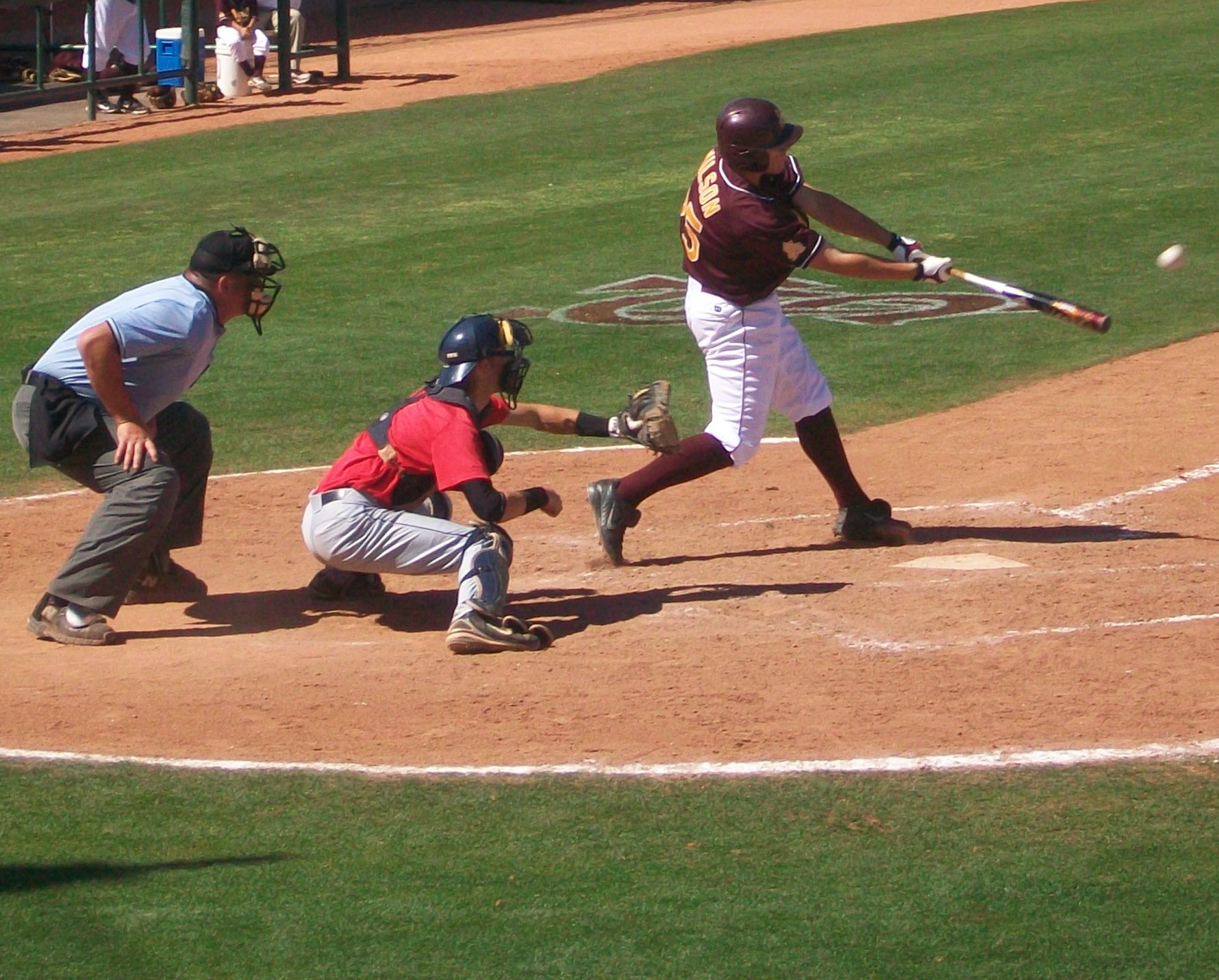 a baseball player swinging his bat at a ball