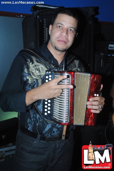 a man with an accordion is posing for a po