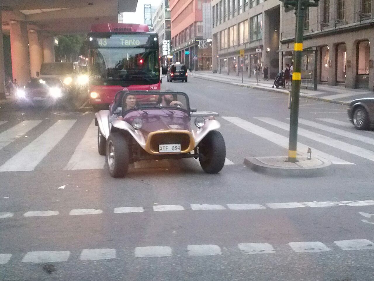 a buggy that is driving down a busy street