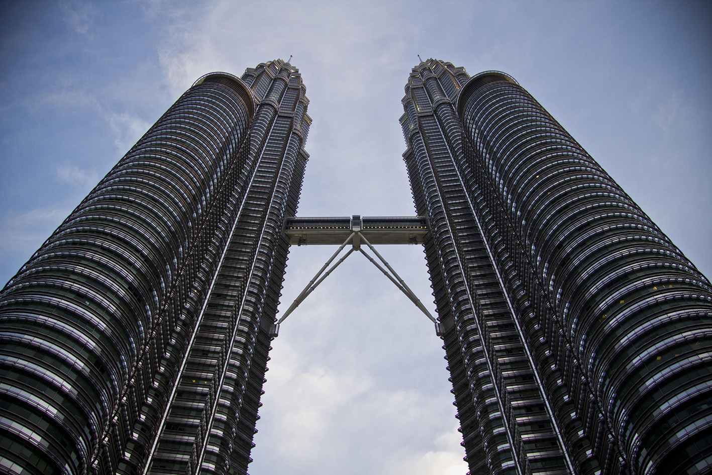 two tall buildings with metal rings on each