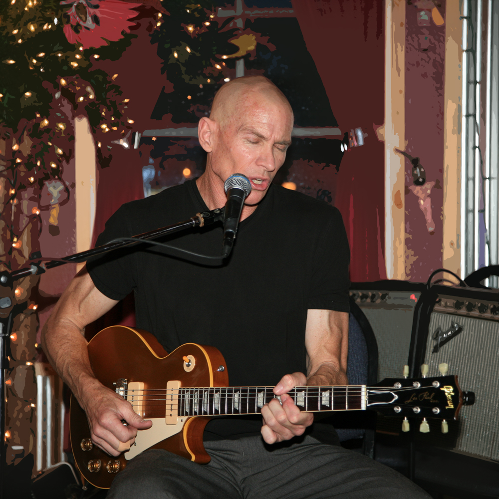 man playing music at a karaoke, with guitar and amplifier