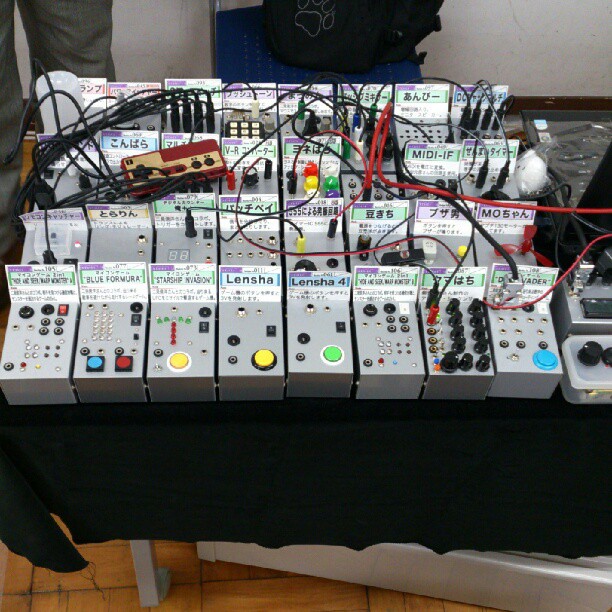 a table covered in electronics and music equipment