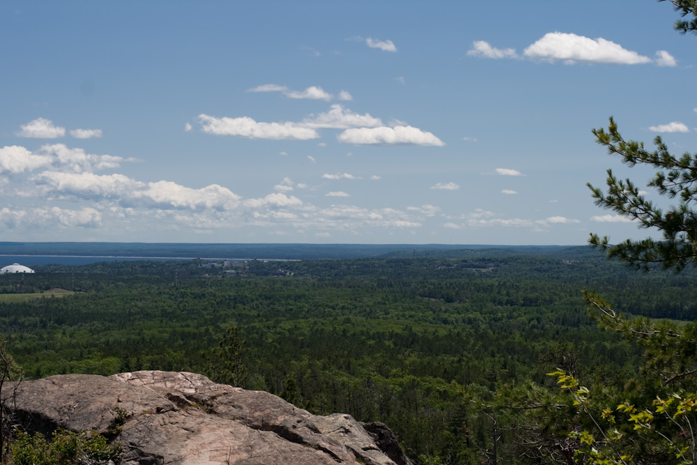 trees line the top of a rock in a remote area