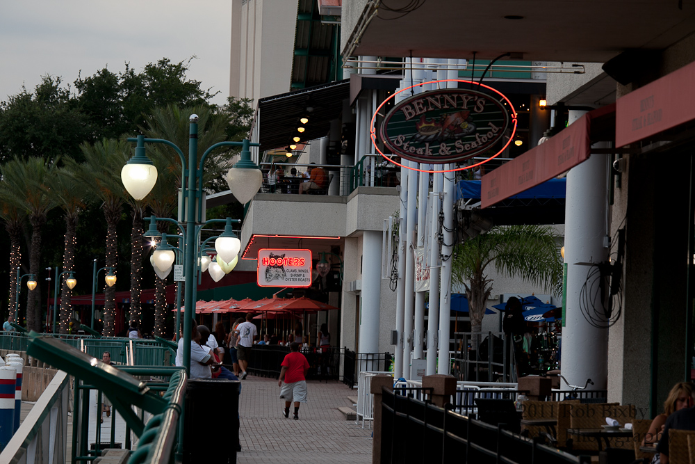 people walking on a walkway in an outdoor setting