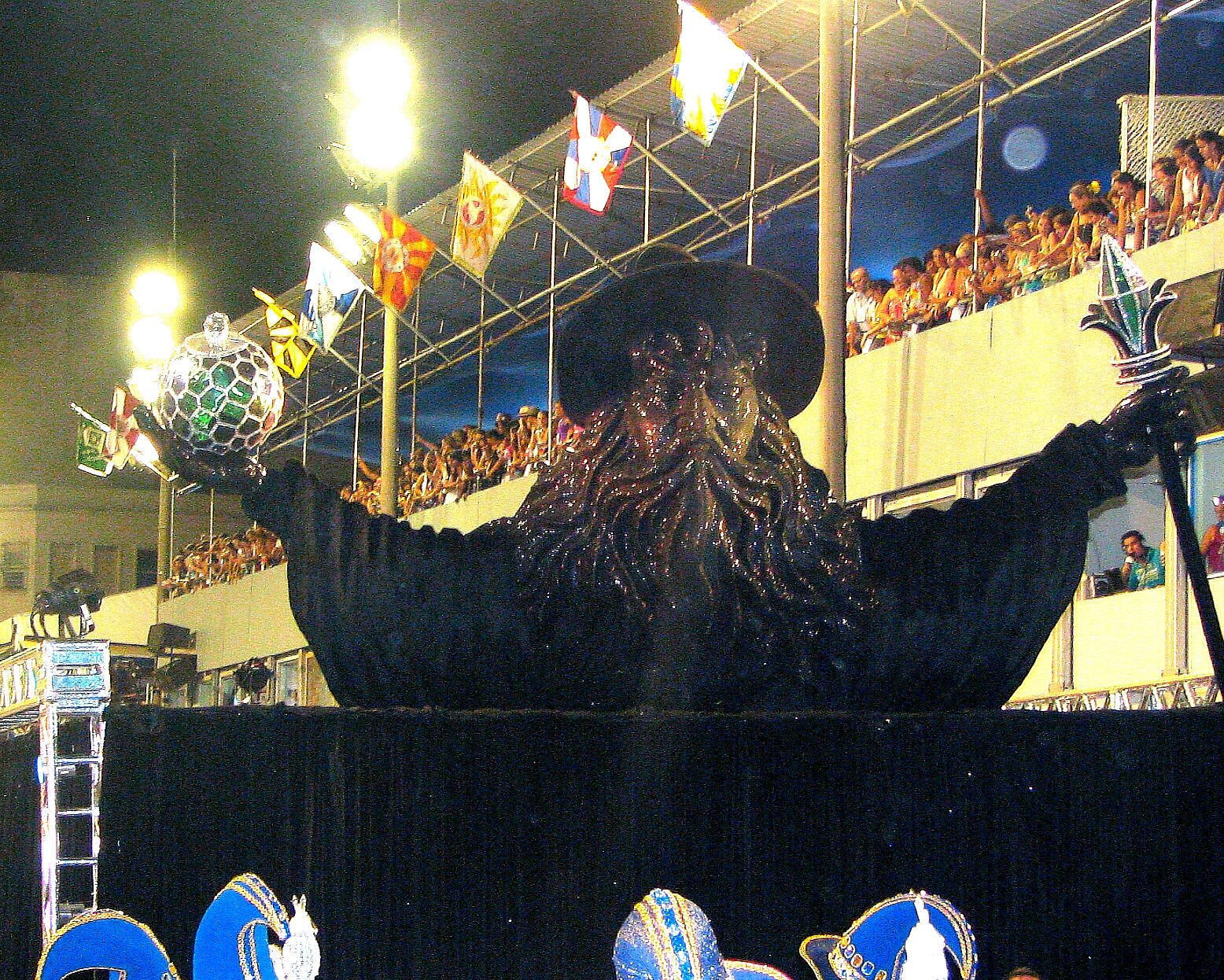 people watching a large animal performing with other performers