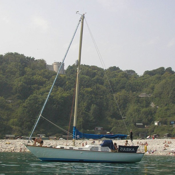 a sailboat out on the lake with others nearby