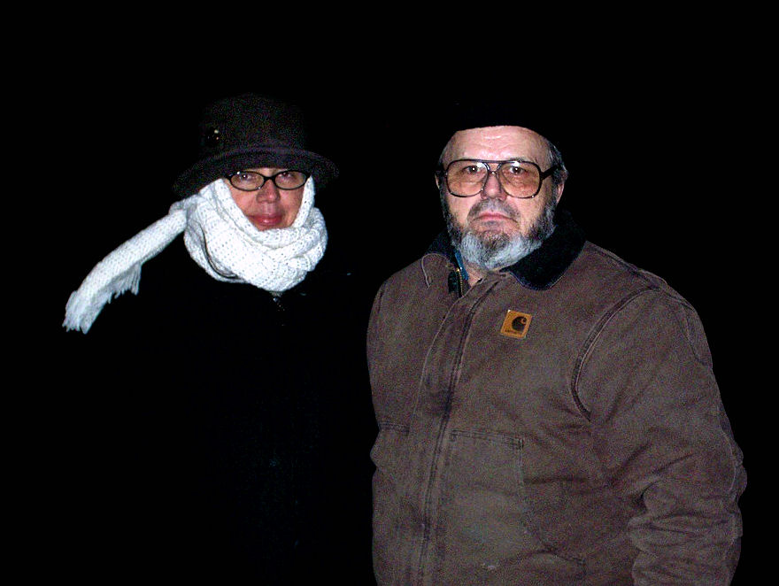 two men with hats and scarves standing next to each other