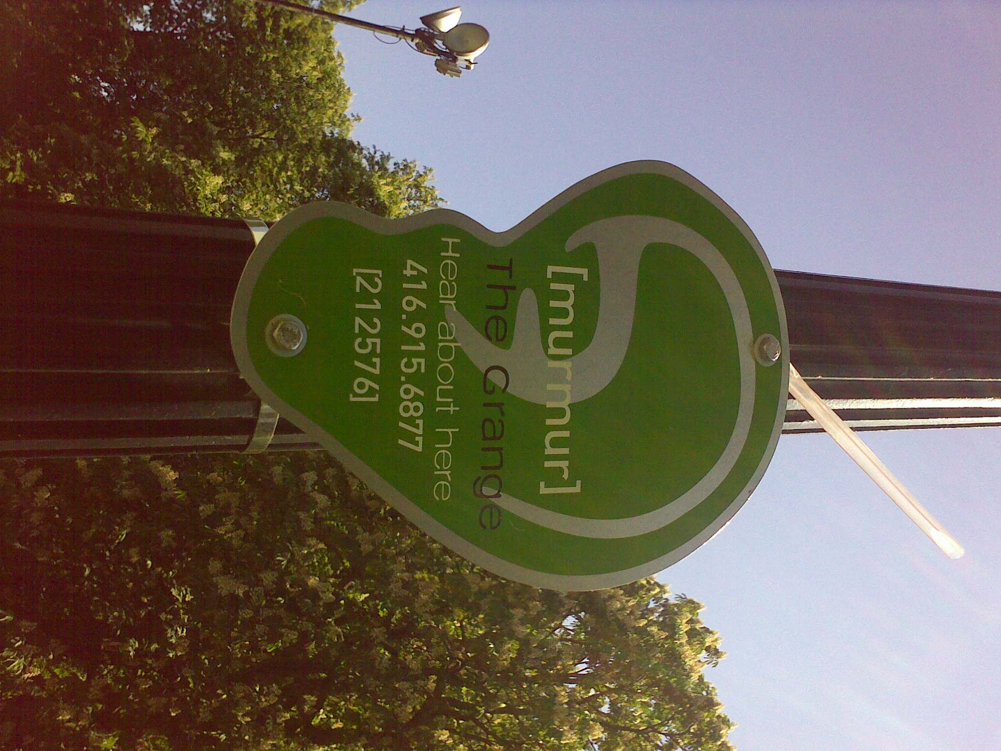 a green street sign on the side of a street