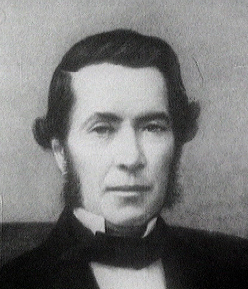 a black and white po of a man wearing a bow tie