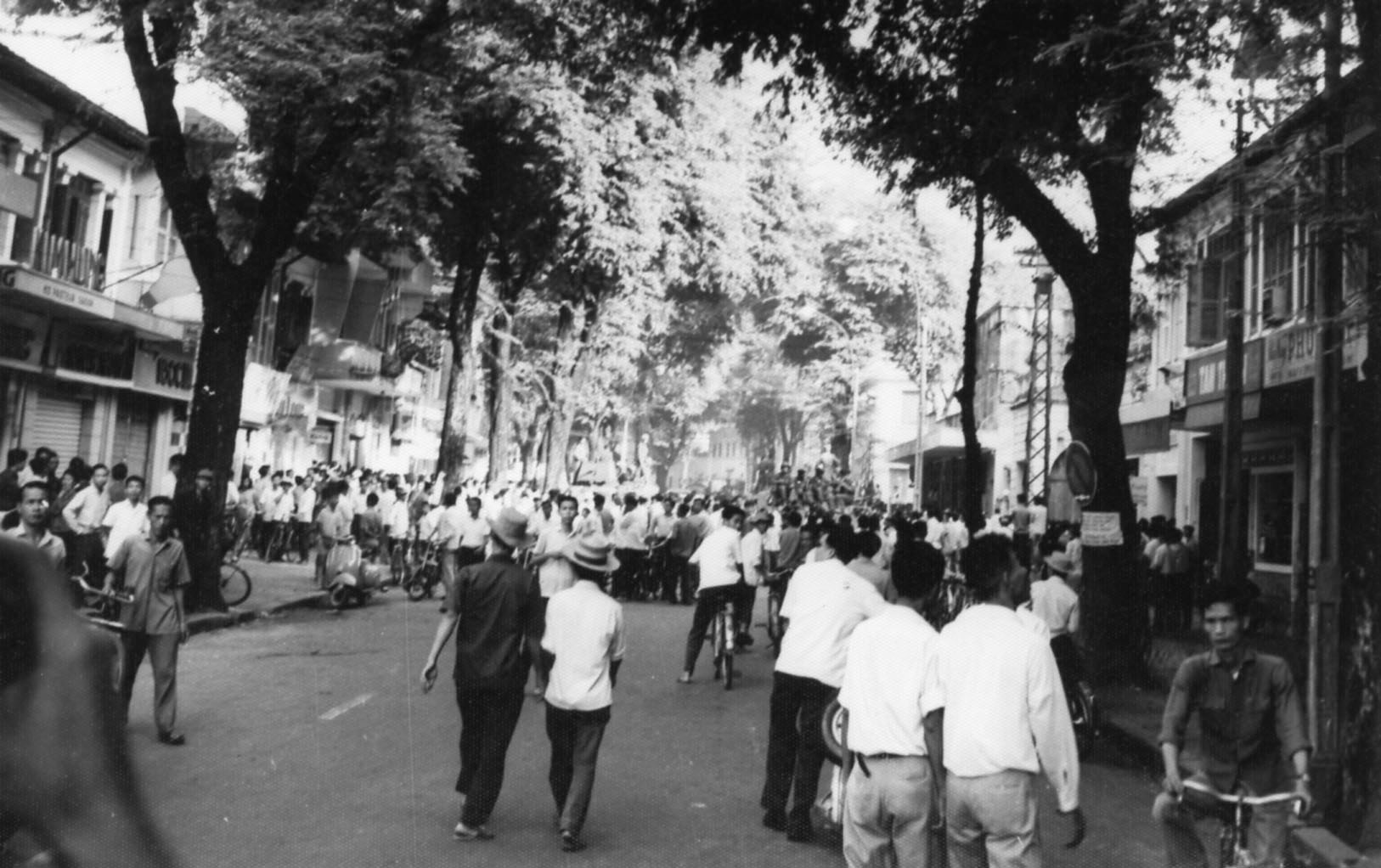 a large crowd of people walking down a street